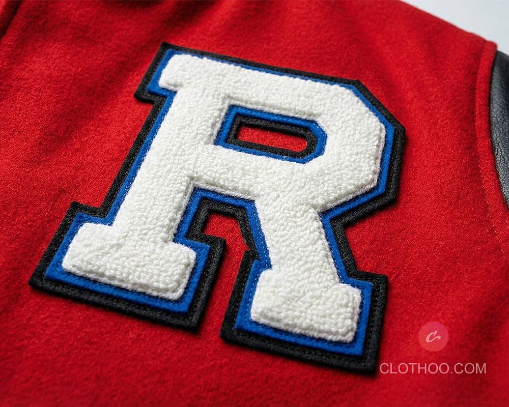 Layered chenille chest letter on varsity jacket