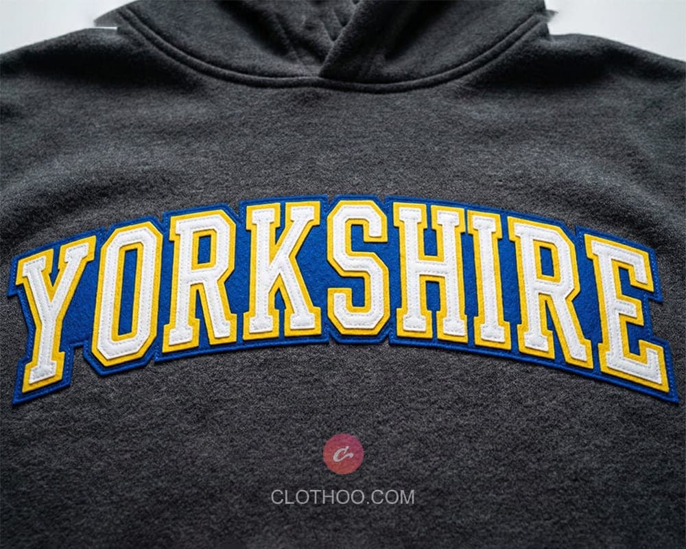 Arc felt lettering stitched across hoodie chest