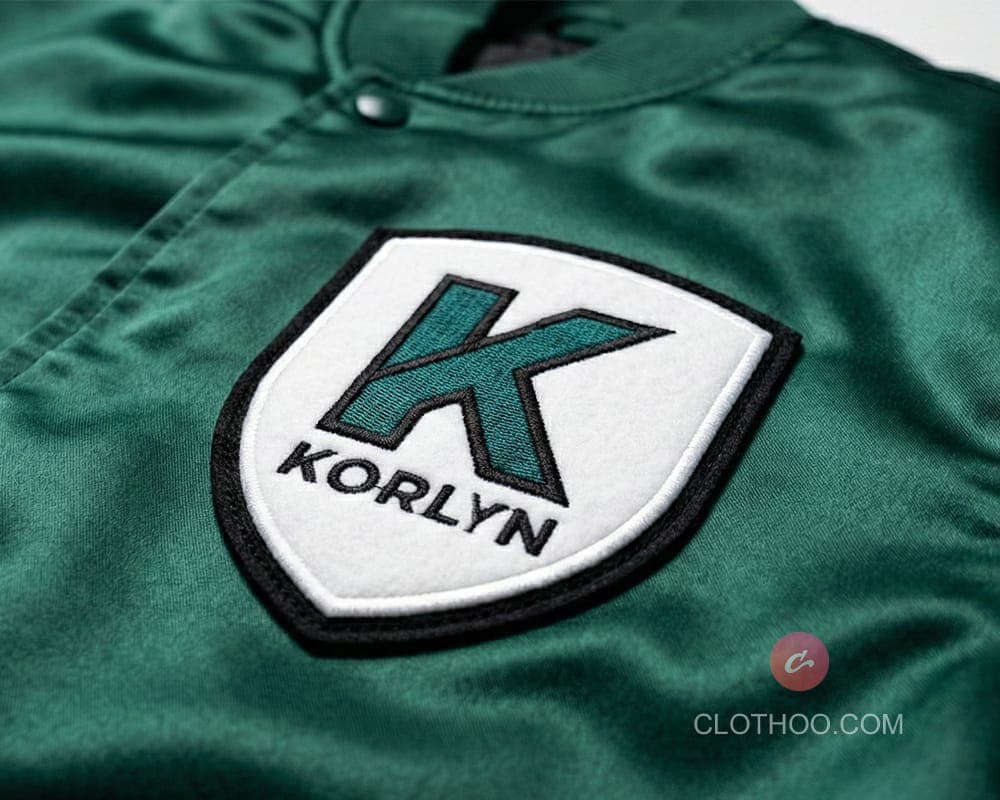 Embroidered logo patch on satin varsity jacket